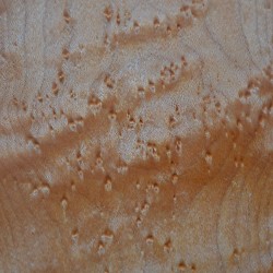Detail of a piece of birds eye maple, waiting to be turned into a violin.